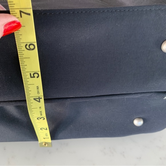 Black Travel Bag with Structured Design and Metal Feet - Picture 15 of 16